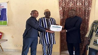 Photo: The Mayor of Sabou, Koara Abdoul Aziz and CHISU Resident Advisor Dr. Rahim Kebe present a certificate to Barro Mamadou, a champion in the fight against rabies in Sabou.