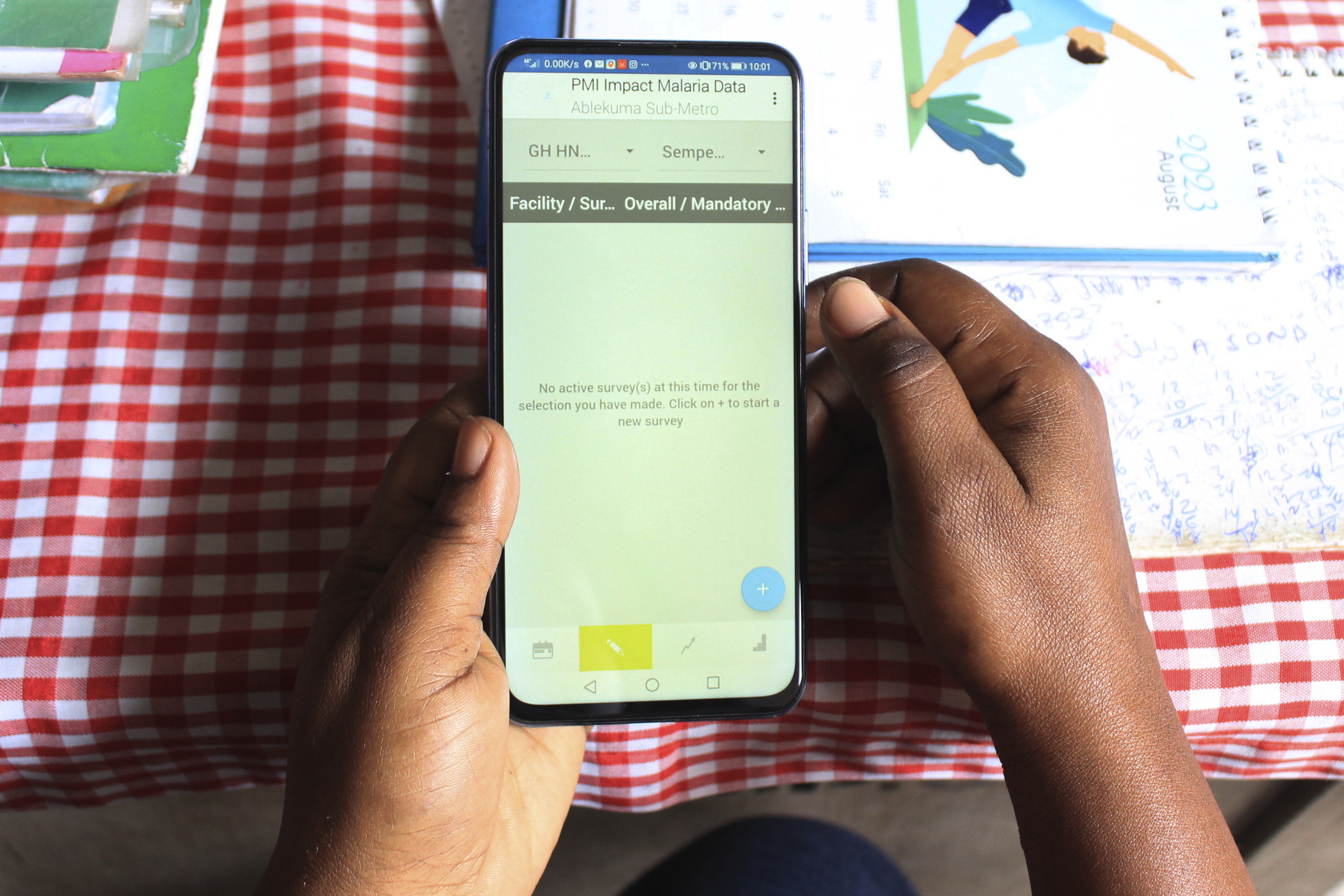 A pair of hands holds a phone, which displays the Ghana Health Service Supportive Supervision digital application on the Health Network Quality Improvement System.