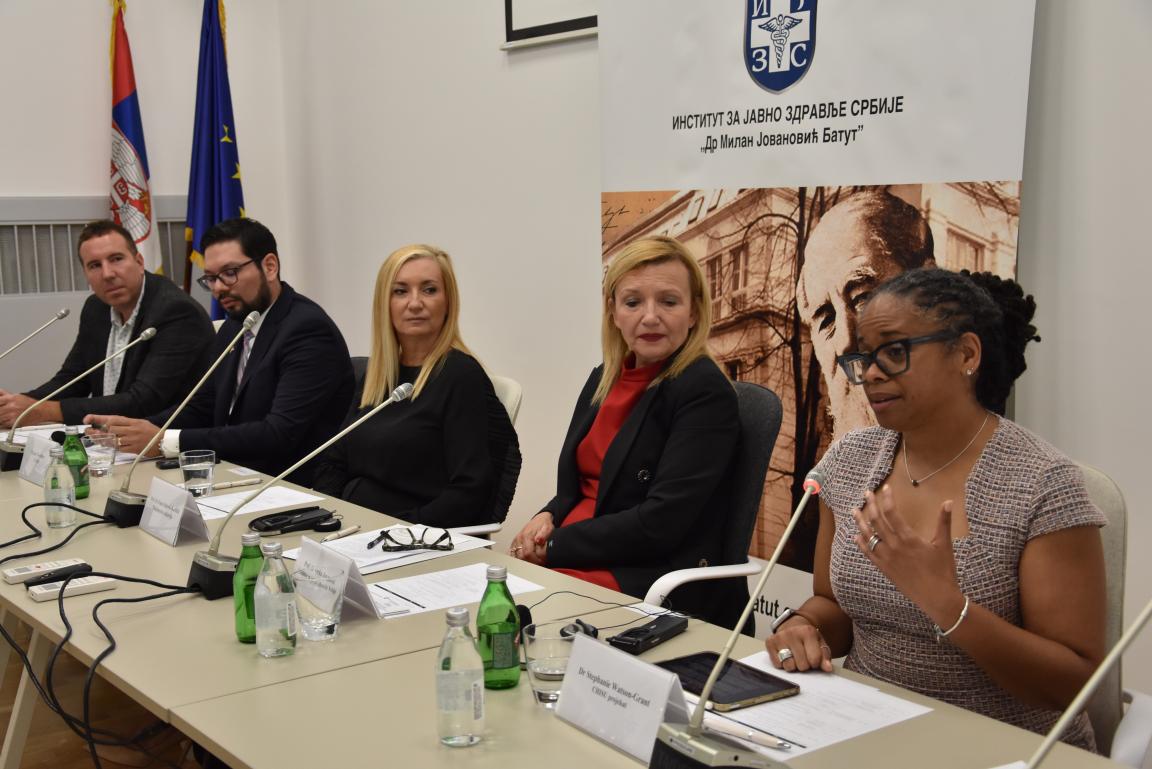 Five people sitting with one speaking