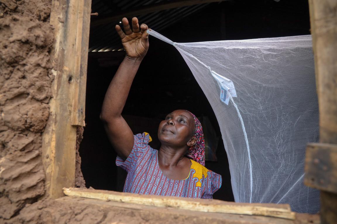 Woman setting up a bednet