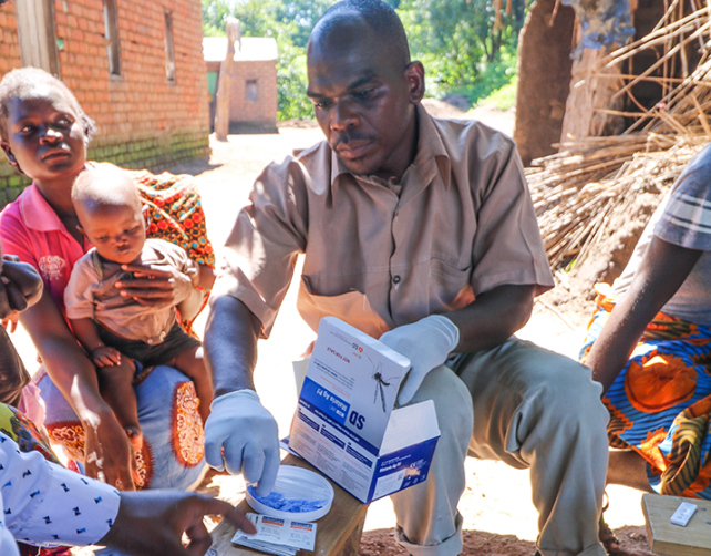 Man distributes malaria tests and treatment